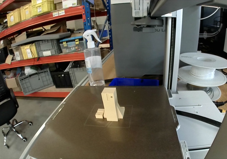 The printed clamp standing on the bed of a Bambu Lab A1 printer