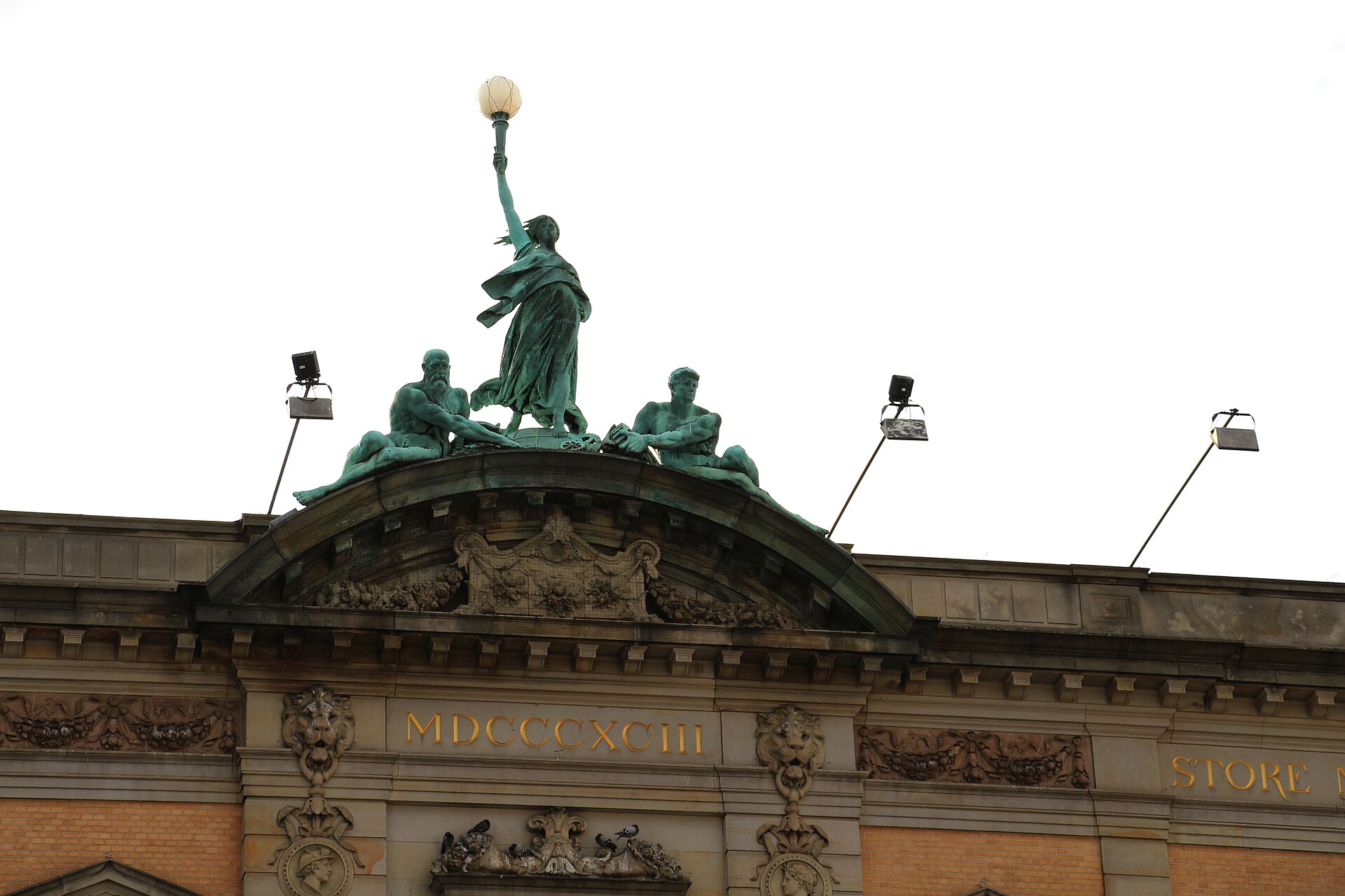 Bronze statues and a lamp on the roof of the former Great Northern Telegraph Company building in Copenhagen